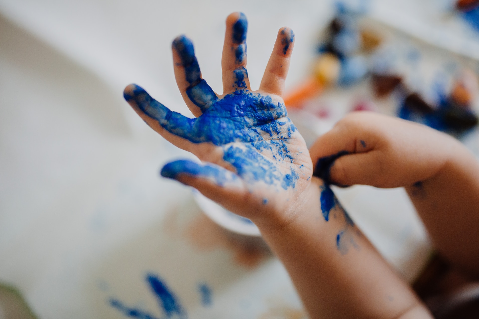 kid hand with blue paint