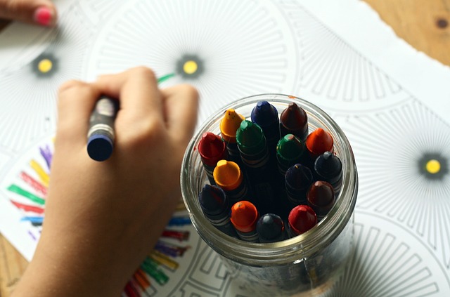 kid drawing with crayons