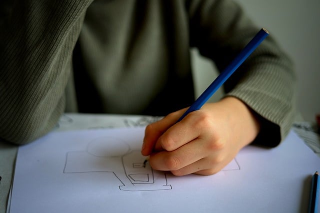 child drawing designing a poster